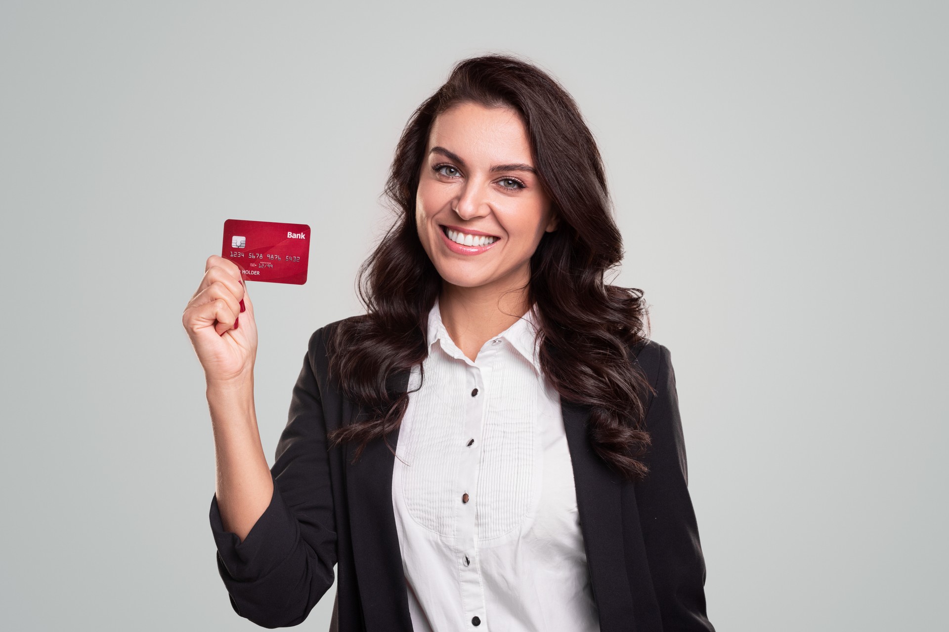 Happy business lady showing credit card